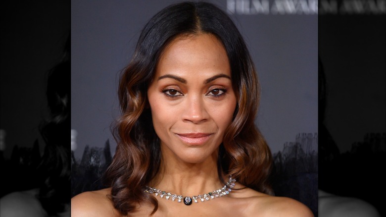 Zoe Saldana smiles on the red carpet in 2025