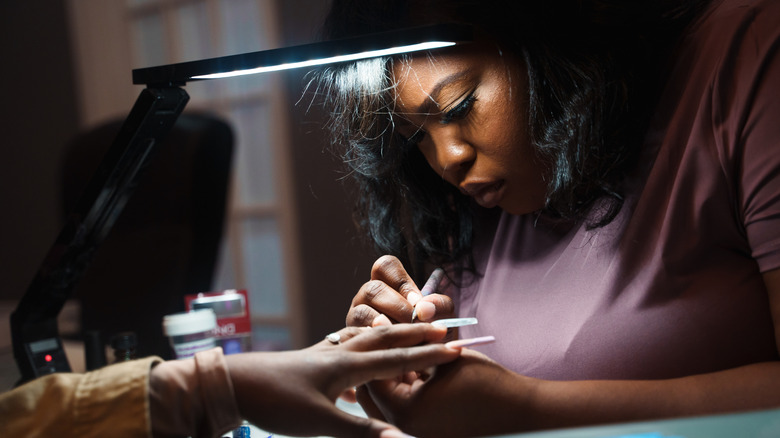 A woman getting her nails done at the nail salon