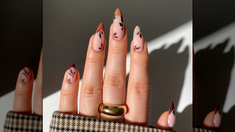 A manicurist shows off her manicure