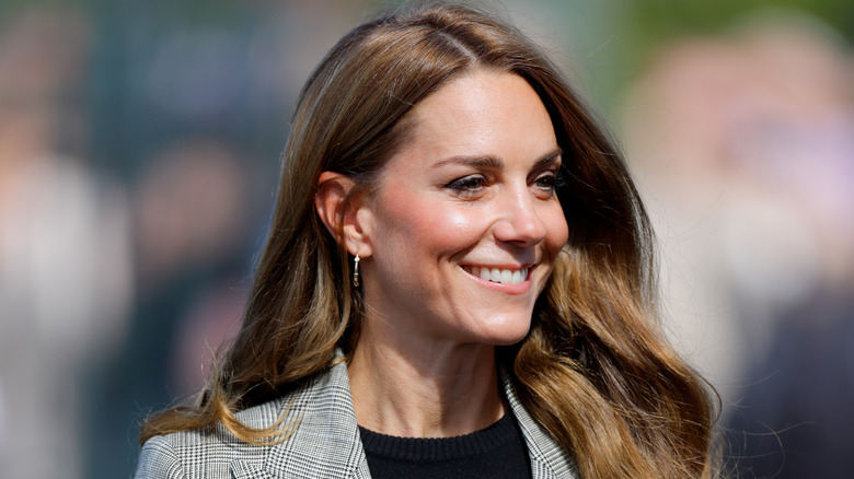 Kate Middleton smiling on a royal engagement
