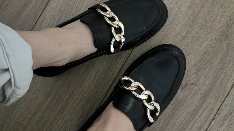 Black loafers on feet