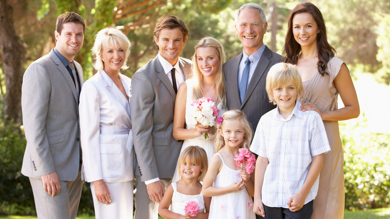 A family posed outside for a wedding portrait