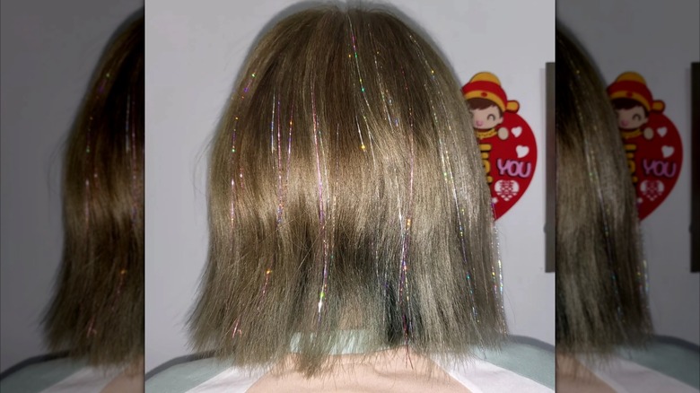 A woman with a bob featuring hair tinsel