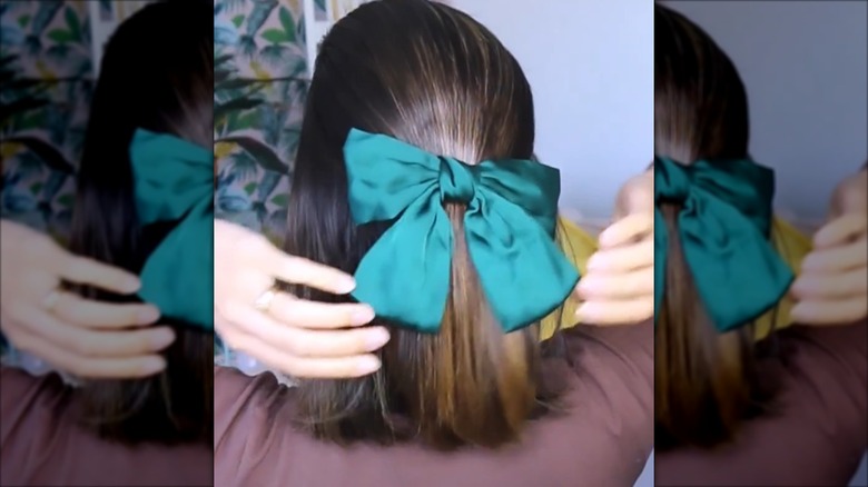 A woman with a bob and large bow