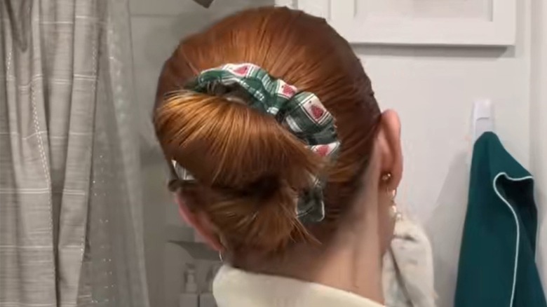 A woman with a festive double bun bob