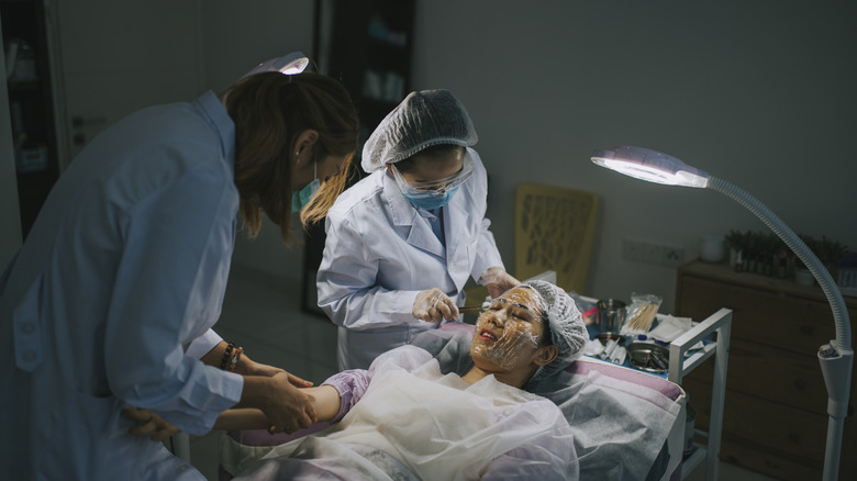 Doctors conducting facial surgery