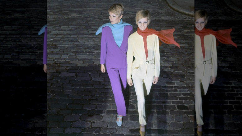 Two mod-style models crossing the road wearing colorful Mary Jane flats