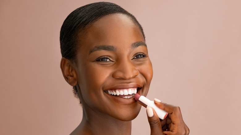 woman applying lipstick