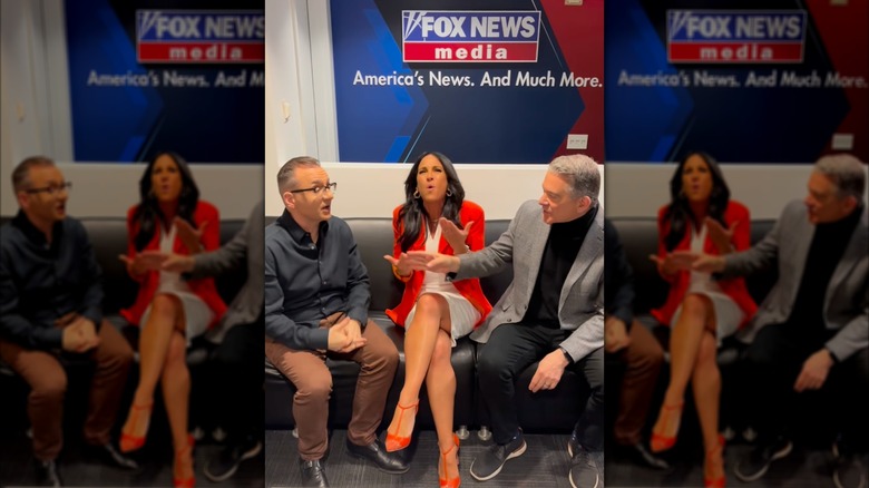 Emily Compagno sits with two men on a sofa at Fox News pretending to argue