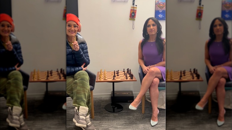 Emily Compango in a purple dress playing chess with a guest holding a microphone