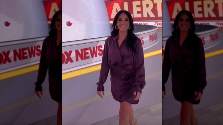 Emily Compagno in a purple dress walking on the Fox News set