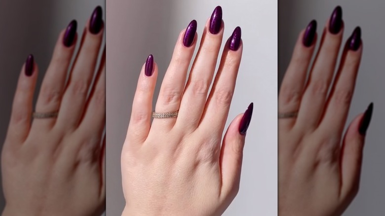 A screen grab of a dark purple manicure video on Instgram