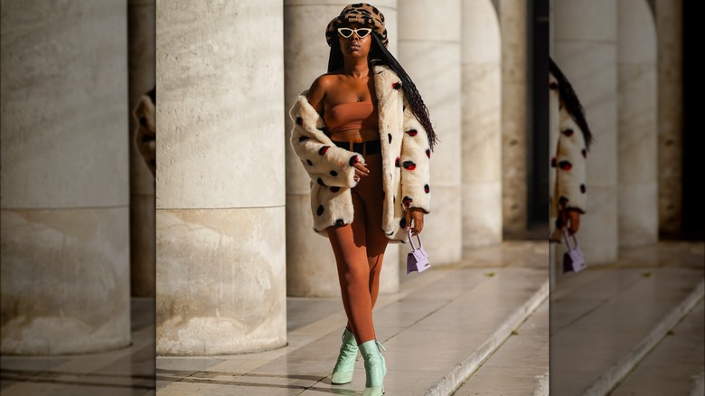 A woman in a fluffy hat and coat 