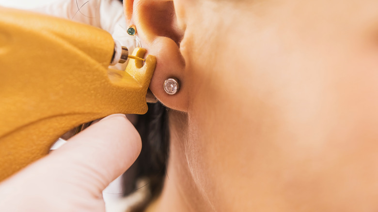 A woman getting a piercing