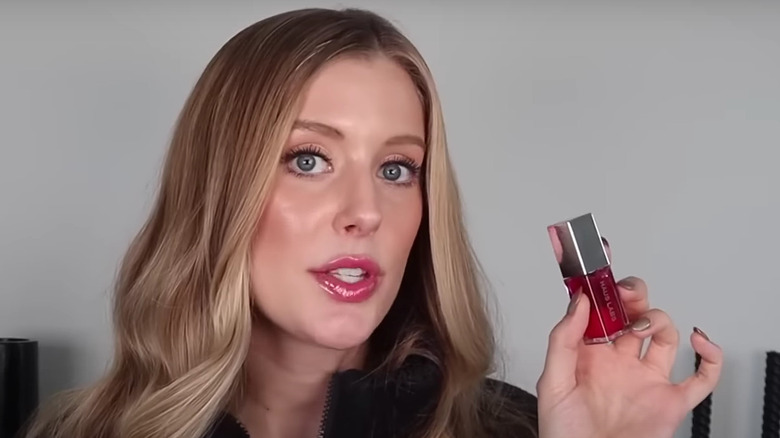woman holding lip oil 
