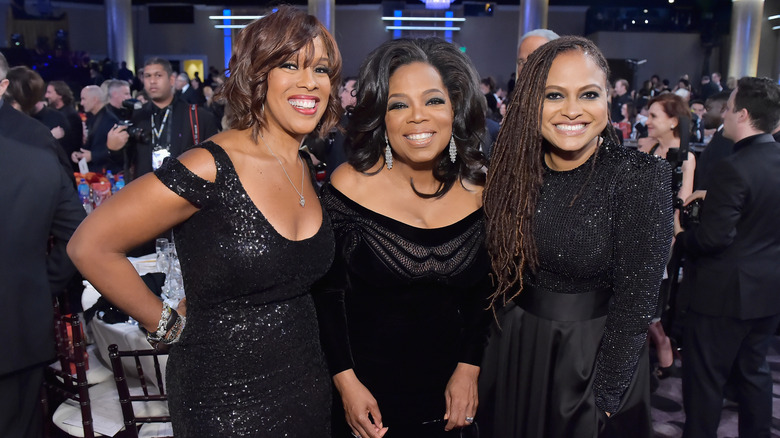 Oprah Winfrey and Gayle King smiling with Ava DuVernay