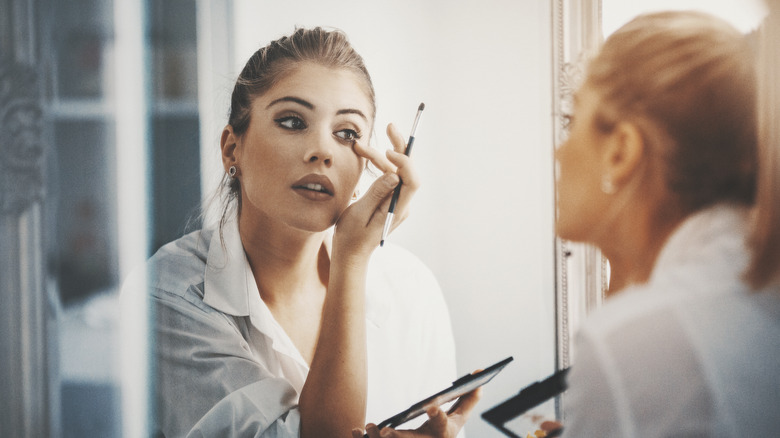 Woman applying eyeshadow