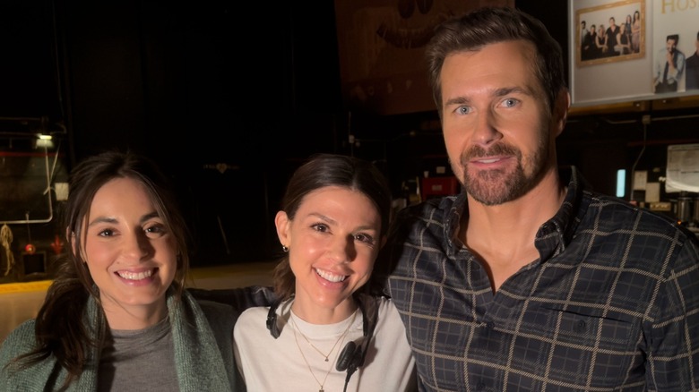 Kate Mansi smiling while standing in the middle of Kristen Vaganos and Josh Kelly.