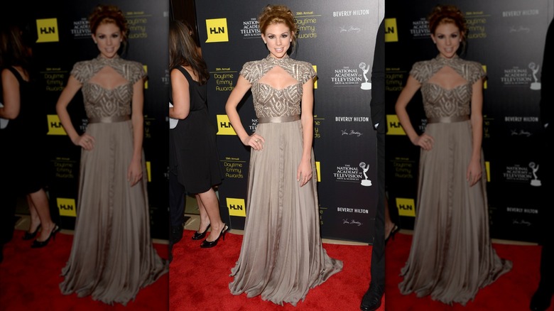 Kate Mansi smiling and posing on the red carpet at the 2012 Daytime Emmys