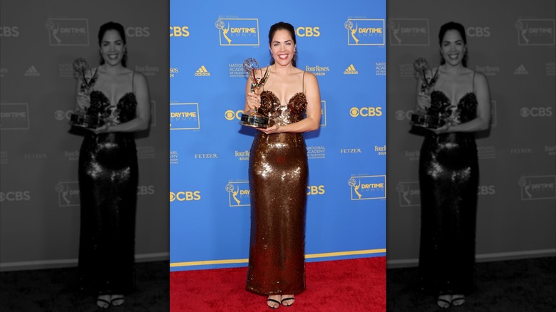 Kelly Thiebaud smiles on the red carpet in 2022 with her award