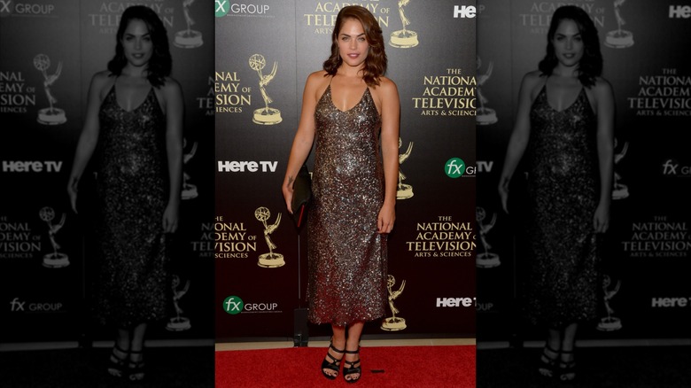 Kelly Thiebaud smiles on the red carpet in 2014