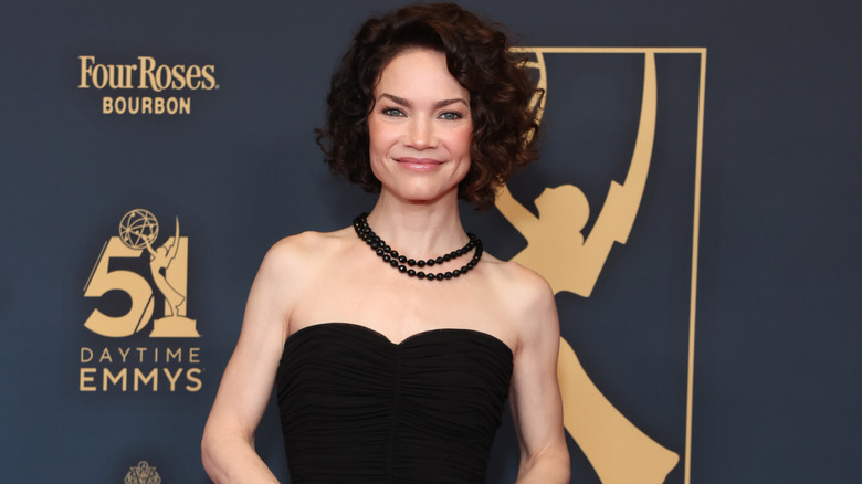 Rebecca Herbst smiles on the red carpet in 2024