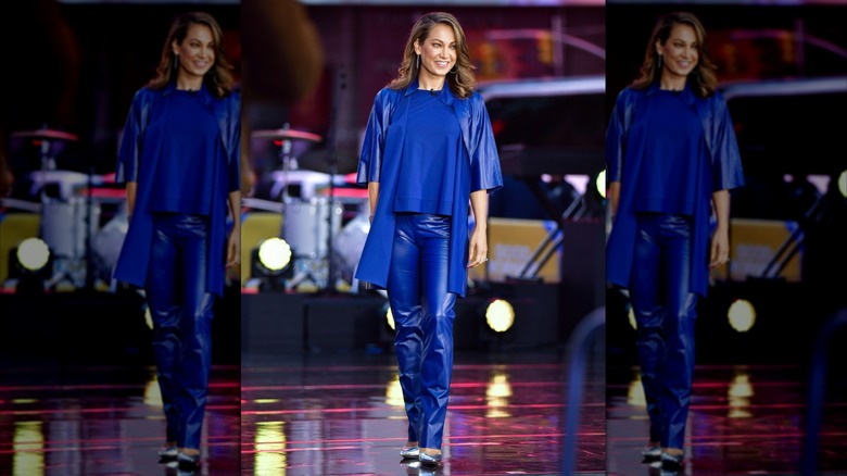Ginger Zee in a blue, leather-look outfit