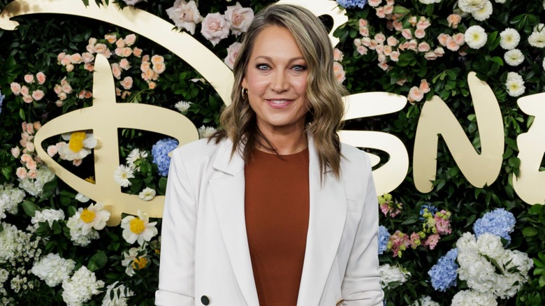 Ginger Zee posing in front of flowers