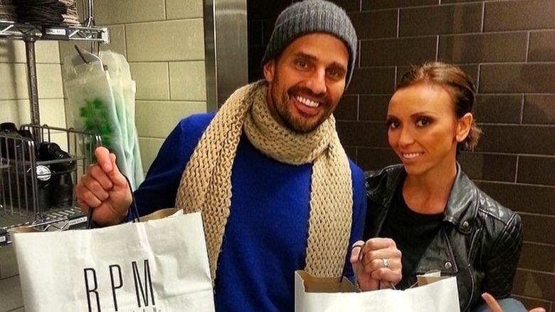 Bill Rancic and Giuliana Rancic holding RMP Italian bags