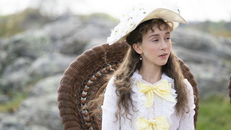 Image of actress Taissa Farmiga on the set of "The Gilded Age," sitting outside
