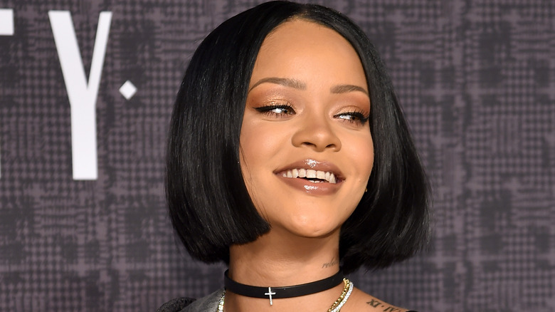 Woman with shiny hair smiling downwards