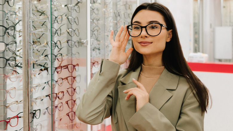 A woman trying on glasses