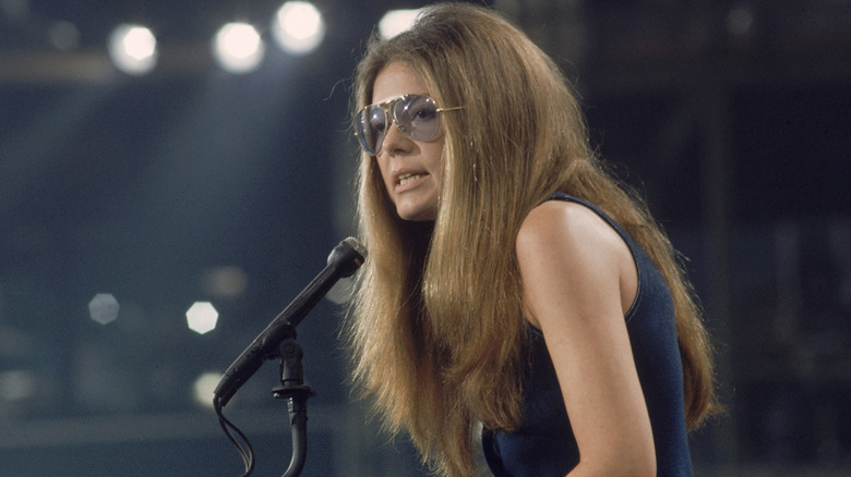Gloria Steinem speaking into a microphone