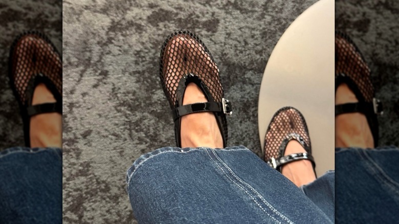 A pair of black mesh Mary Jane flats