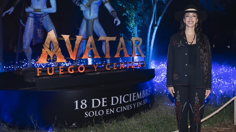 Oona Chaplin standing in front of an "Avatar: Fire and Ash" sign in Mexico in 2025