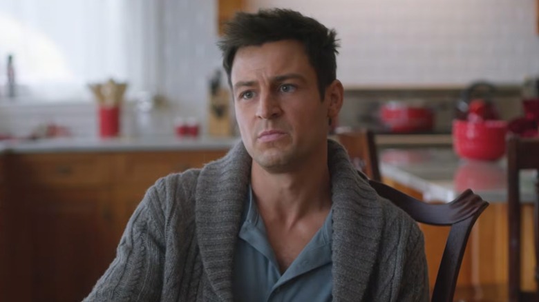 Tyler Hynes in a gray sweater on the set of "An Unexpected Christmas"