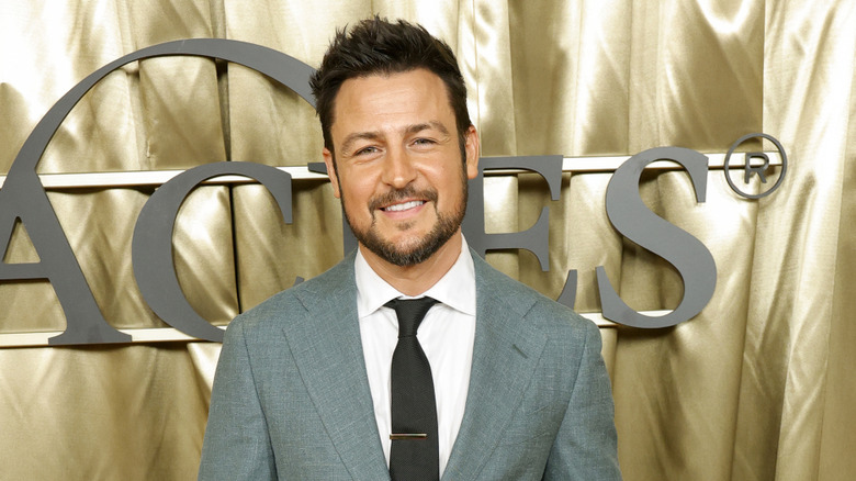 Tyler Hynes in a gray suit at an event