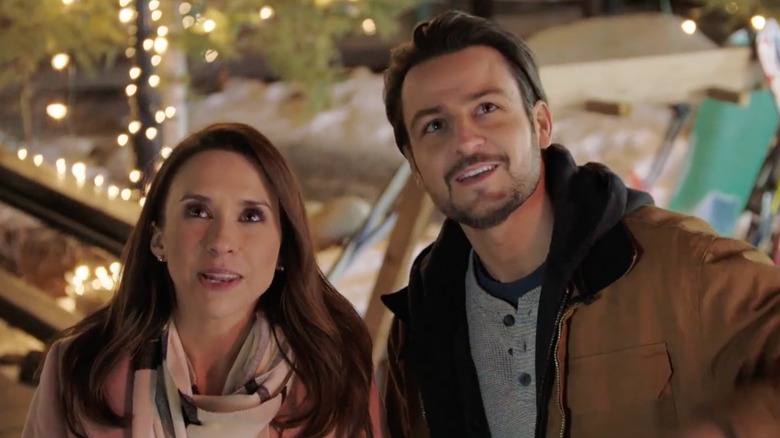 Tyler Hynes and Lacey Chabert in a pink coat on the set of "Winter in Vail."
