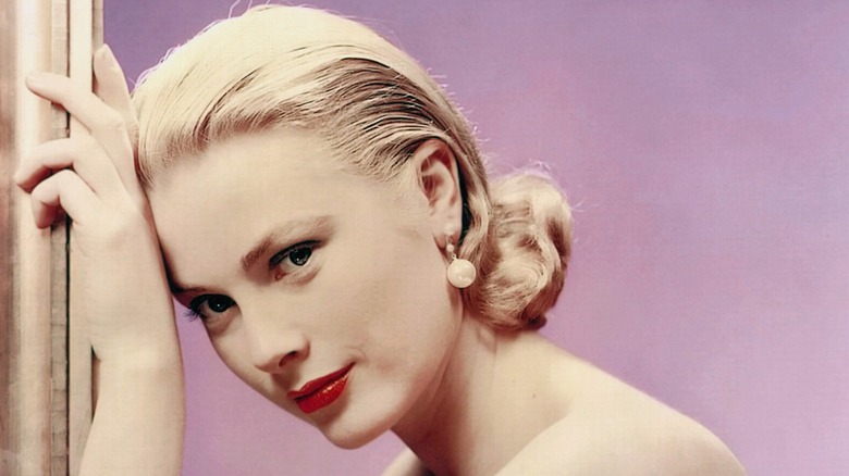Photo of actress Grace Kelly with slicked back hair and red lipstick (circa 1955)