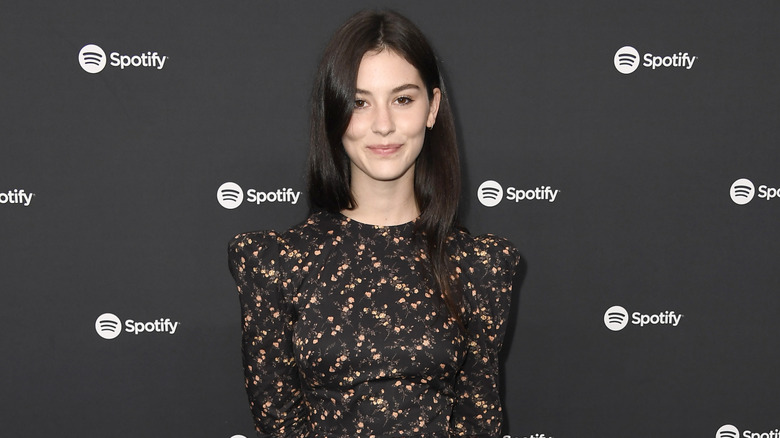 Gracie Abrams wearing a black, floral dress