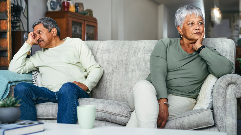 Elderly man and woman sitting on a couch