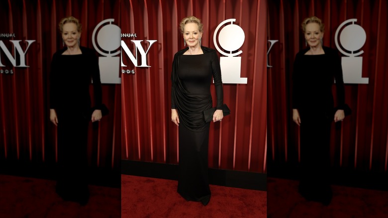 Jean Smart smiles wearing a black maxi dress