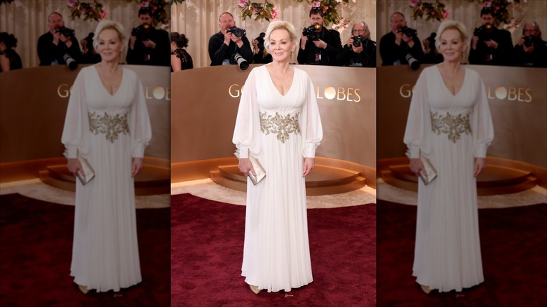 Jean Smart smiles wearing a white balloon sleeve gown