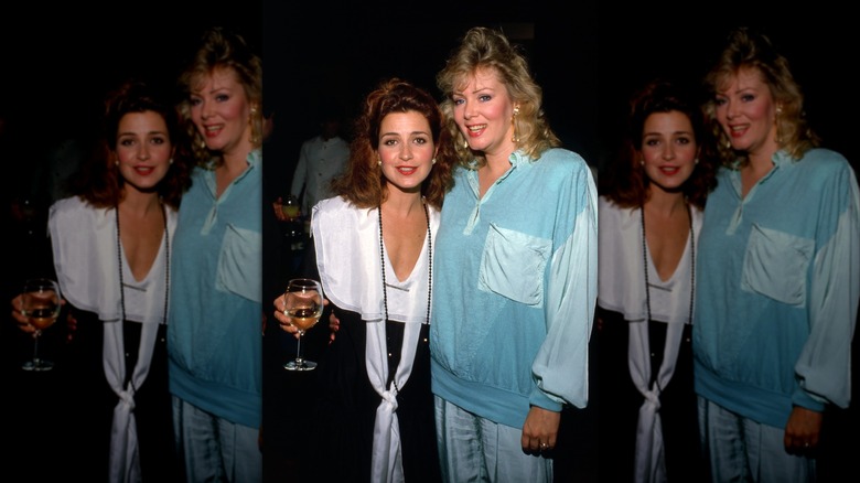 Annie Potts (L) smiles next to Jean Smart (R) who is wearing a light blue tracksuit