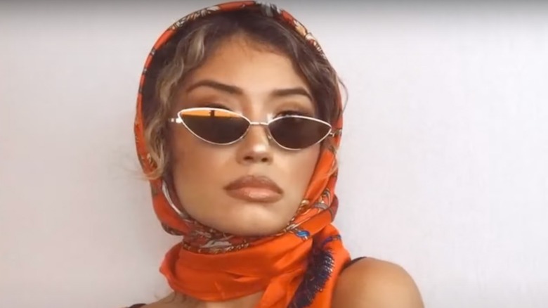 Woman on YouTube styling a silk scarf 