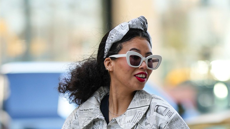 woman with curly hair in a scarf