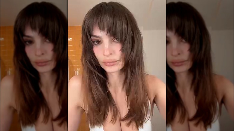 Emily Ratajkowski posing with long, dark hair with deep, full bangs