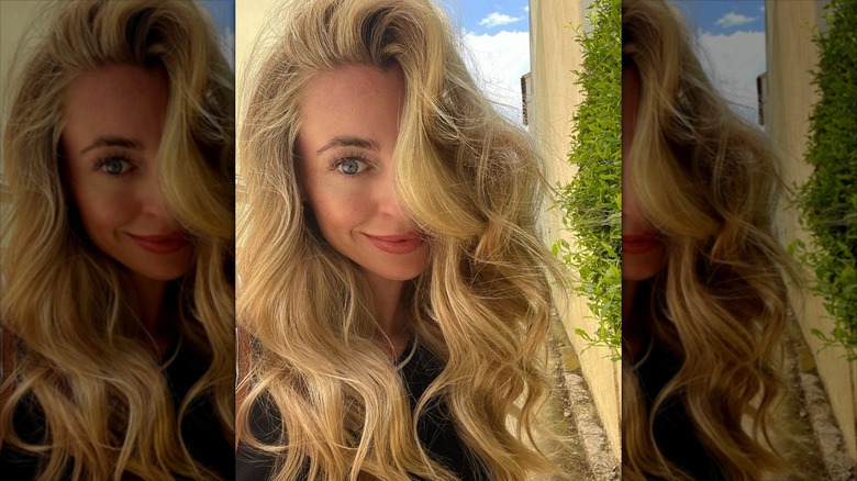 A woman with long, honey blond hair