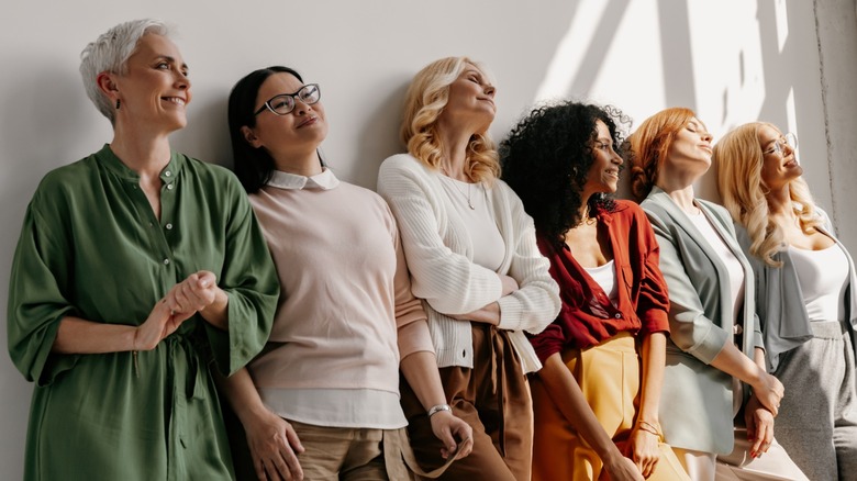 A group of women standing by a wall