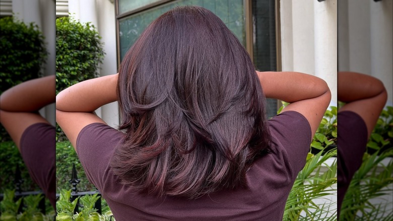 A woman with short, mahogany brown hair